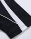 A close-up of a black polo shirt with white stripes, featuring a logo on the fabric.