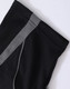 A black polo shirt featuring a grey stripe and a logo, made from breathable fabric.
