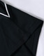 A black polo shirt with a white trim at the collar and sleeve. It features a logo on the fabric.