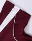 A burgundy polo shirt with white detailing and stitching, featuring a logo on the collar.