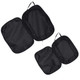 A set of three black compression packing cubes with zippers and handles for easy organisation.