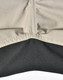 A close-up of Rip-Stop poly/cotton stretch work pants, featuring a beige upper section and a black lower section with stitching.