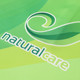 A green polo shirt featuring a swirling logo and the word "naturalcare" in white.