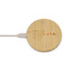 A round bamboo wireless charger with a white charging cable connected. It features a minimal design and has a logo.