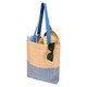 A tote bag in beige and blue with long handles, featuring a pair of sunglasses and round items inside.