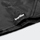 A black camping blanket with a logo tag, featuring textured fabric and a folded edge.
