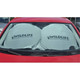 A foldable car shade in light grey, featuring a logo, placed inside the windshield of a red car.