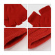 Red fingerless gloves with a knitted texture and woven label, featuring an open fingertip design.