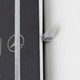 A black A5 notebook with a silver elastic band and a logo on the cover.