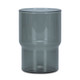 A drink tumbler in a transparent smokey grey colour with a distinctive curved design. Includes a logo.