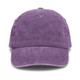 A vintage washed cap in a rich purple hue with a logo. Features a classic curved brim and soft fabric texture.