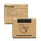 A brown cardboard box containing a Candid Mini Camera with a key ring attachment. It features a camera graphic on the front.