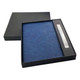 A navy notebook and pen set presented in a black gift box, featuring a sleek design and a logo.