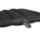 A black bubble neoprene laptop sleeve with a zip closure, featuring padded sections for protection.