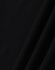 A close-up of black ultrafine cotton pique fabric, textured with a smooth finish. It features subtle folds.