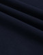A close-up of navy ultrafine cotton pique fabric, showcasing its texture and weave.
