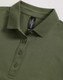 A green ladies polo shirt with a collared neck and a button placket, featuring a logo tag inside.