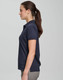 A navy ultrafine cotton pique polo is displayed, featuring a collar and short sleeves, worn by a model.