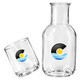 A glass carafe and cup set in clear glass, featuring a logo, with a sleek design.
