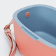 A drink cooler featuring a pink exterior and blue interior, with a handle and a fastening button.