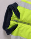 A unisex hi-vis hooded puffer vest in fluorescent yellow with navy accents and reflective strips.