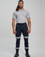 Cotton stretch drill cuffed work pants in navy blue with reflective tapes, worn by a model.