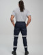 Cotton stretch drill cuffed work pants in navy with reflective tape, viewed from behind on a model.