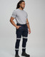 A man wearing navy cotton stretch drill cuffed work pants with reflective tape, paired with a grey t-shirt and black boots.