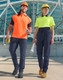 A man in an orange polo and a woman in a bright yellow polo wear navy DWR water-repellent flexi work pants.
