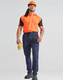 A worker models DWR water repellent flexi work pants in navy, paired with an orange shirt and safety gear.