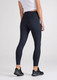 A pair of women's 7/8 length leggings in navy blue with a high waistband, featuring a logo.