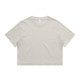 A light beige cropped t-shirt featuring short sleeves and a round neckline. The shirt has a simple design and a logo.