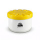 A white air freshener container with a yellow lid, featuring a logo on the front.