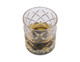 A crystal tumbler with a whisky drink inside, featuring a diamond-cut design and clear glass.