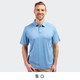 A men's polo in light blue, featuring a collar, buttons, and a logo. Model is smiling and standing.