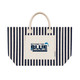 A striped tote bag with a cream base and navy blue stripes. It features a front pocket and a logo.