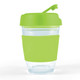 A reusable coffee cup with a transparent body and a bright green lid and sleeve. It has a logo present.