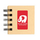 A spiral-bound notebook with a kraft cover featuring a white elephant logo and the text "WILD TUSK DEFENDERS."