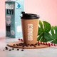 A reusable coffee cup with a natural cork exterior and a black lid, surrounded by coffee beans and a striped straw.