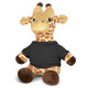 A plush giraffe toy with a tan and brown pattern, wearing a dark shirt, sitting upright.