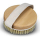 A round wooden body brush with a soft bristle edge and a fabric strap for grip.
