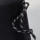A black Bluetooth speaker with textured surface and a decorative cord attached.