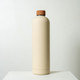 A drink bottle in a cream colour with a brown lid, featuring a minimalist design and a small logo.