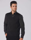 A men's black 100% Merino wool V-neck vest worn over a dark shirt, featuring a fitted design.