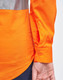 An orange long-sleeve work shirt with perforated reflective tape, featuring buttoned cuffs.