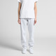 Light grey track pants with an elastic waistband and cuffs, paired with a plain white t-shirt and white sneakers.