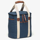 A drink cooler in navy blue with cream straps and brown leather accents, featuring a zippered pocket.
