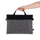 A grey felt satchel with a black top, featuring a zippered closure and dual handles.