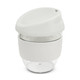 A drink bottle in a sleek design features a clear base and a soft white lid with a silicone grip band.