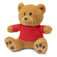 A plush teddy bear in light brown with a red shirt, featuring soft fur and round ears. It has a branding logo.